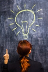 21561775 - redhead businesswoman at blackboard having bright idea