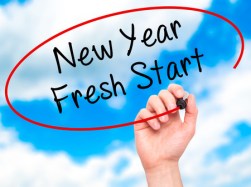52800366 - man hand writing new year fresh start with black marker on visual screen. isolated on sky. business, technology, internet concept. stock photo