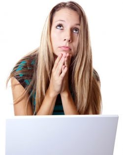 woman with laptop praying
